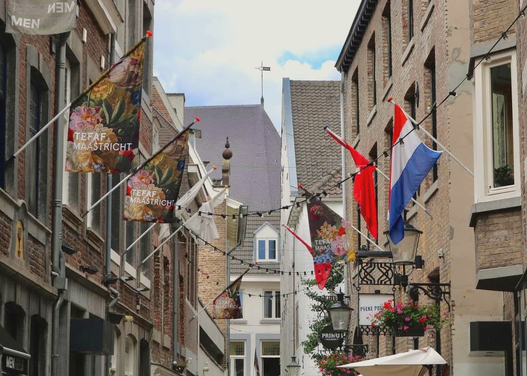 Maastricht street hung with TEFAF Maastricht banners and a Dutch flag